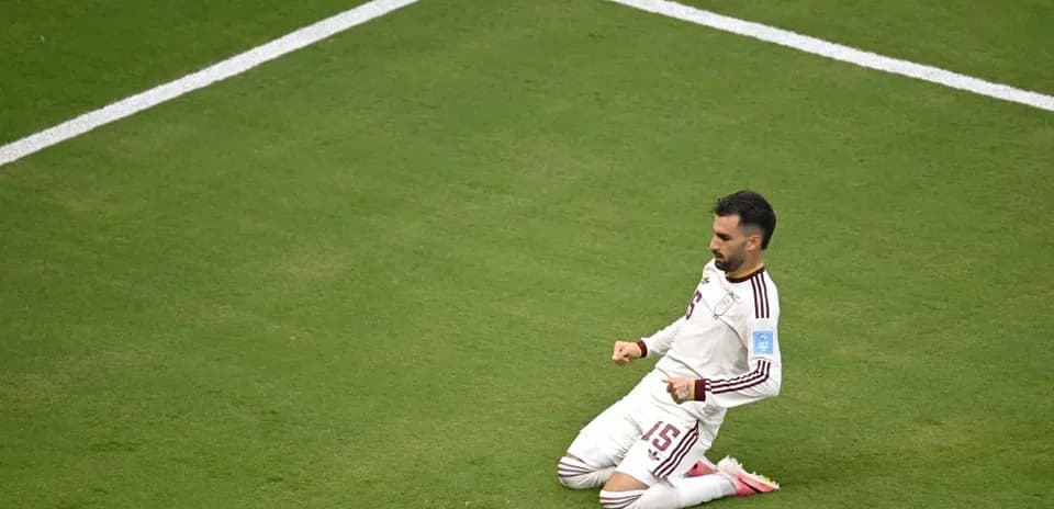 Player celebrating on the pitch after scoring