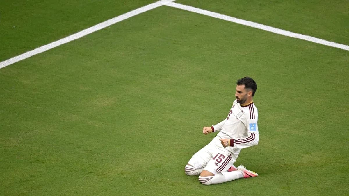 Player celebrating on the pitch after scoring