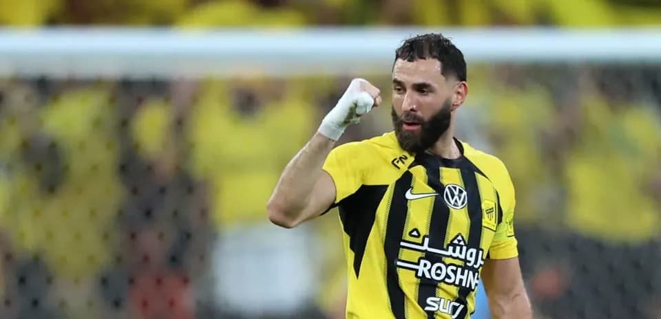 Player celebrating a goal in yellow and black uniform