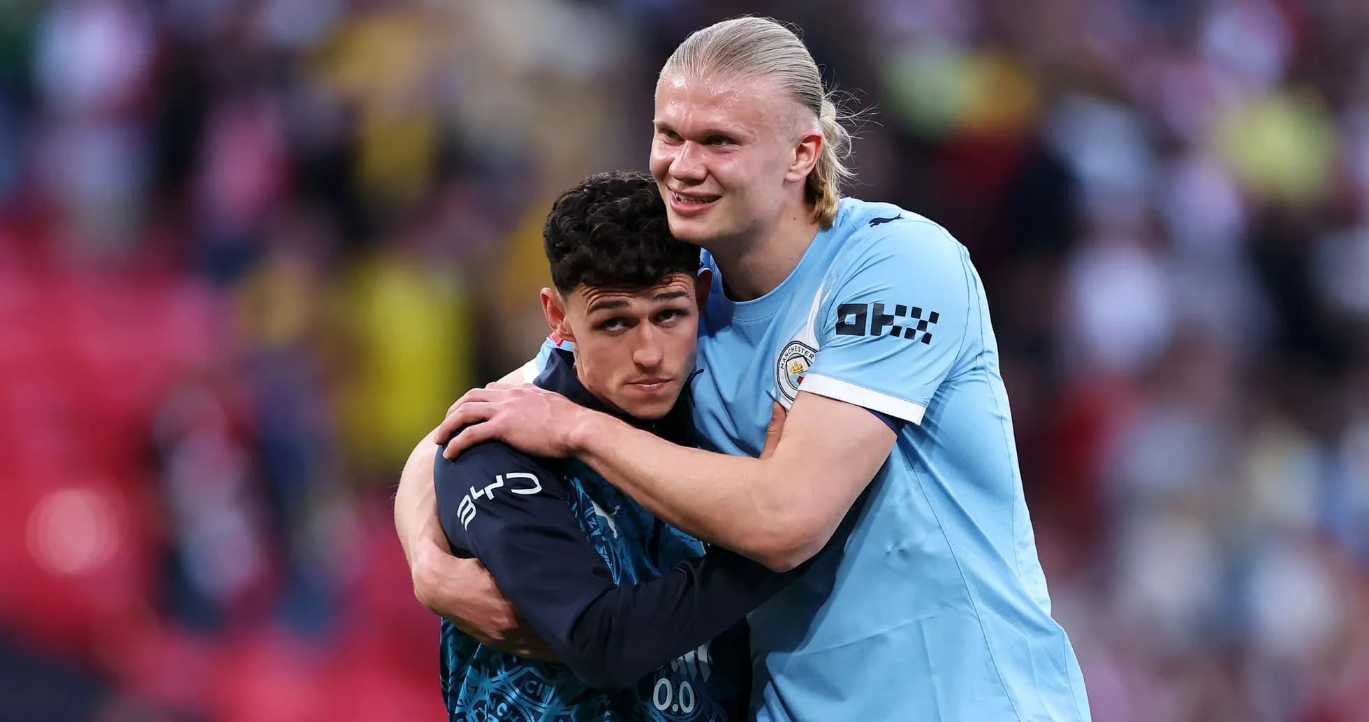 Two Manchester City players embracing after match