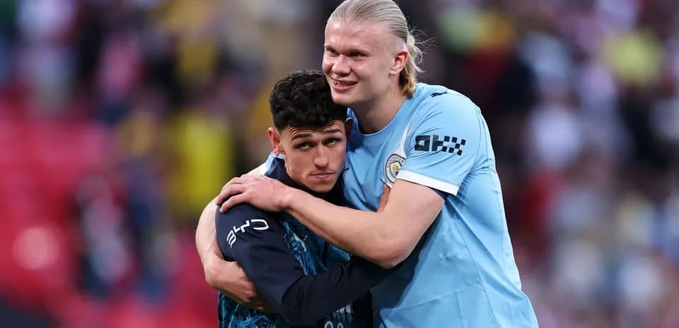 Two Manchester City players embracing after match