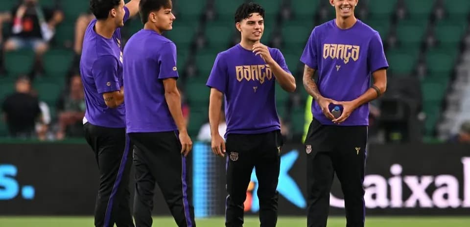 Players warming up in purple training shirts on pitch