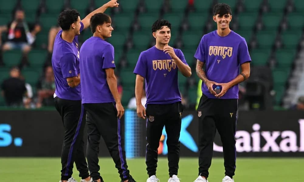 Players warming up in purple training shirts on pitch