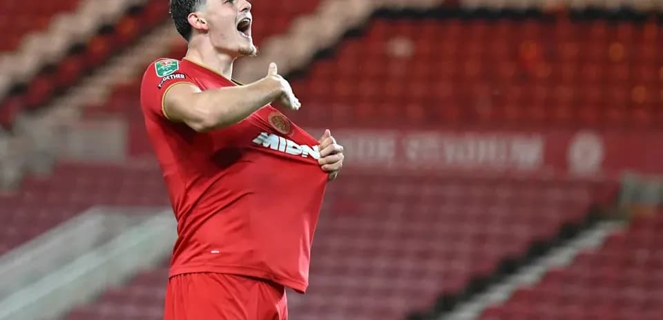 Player celebrating and lifting shirt after scoring goal