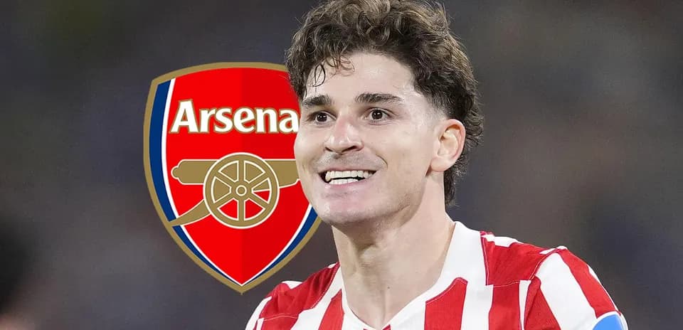 Player smiling with Arsenal logo in background
