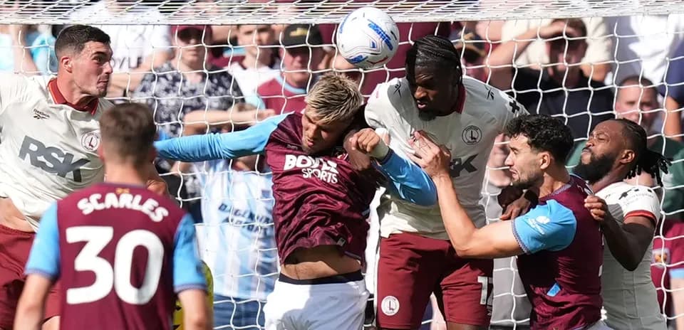 Players contesting a header near the goal