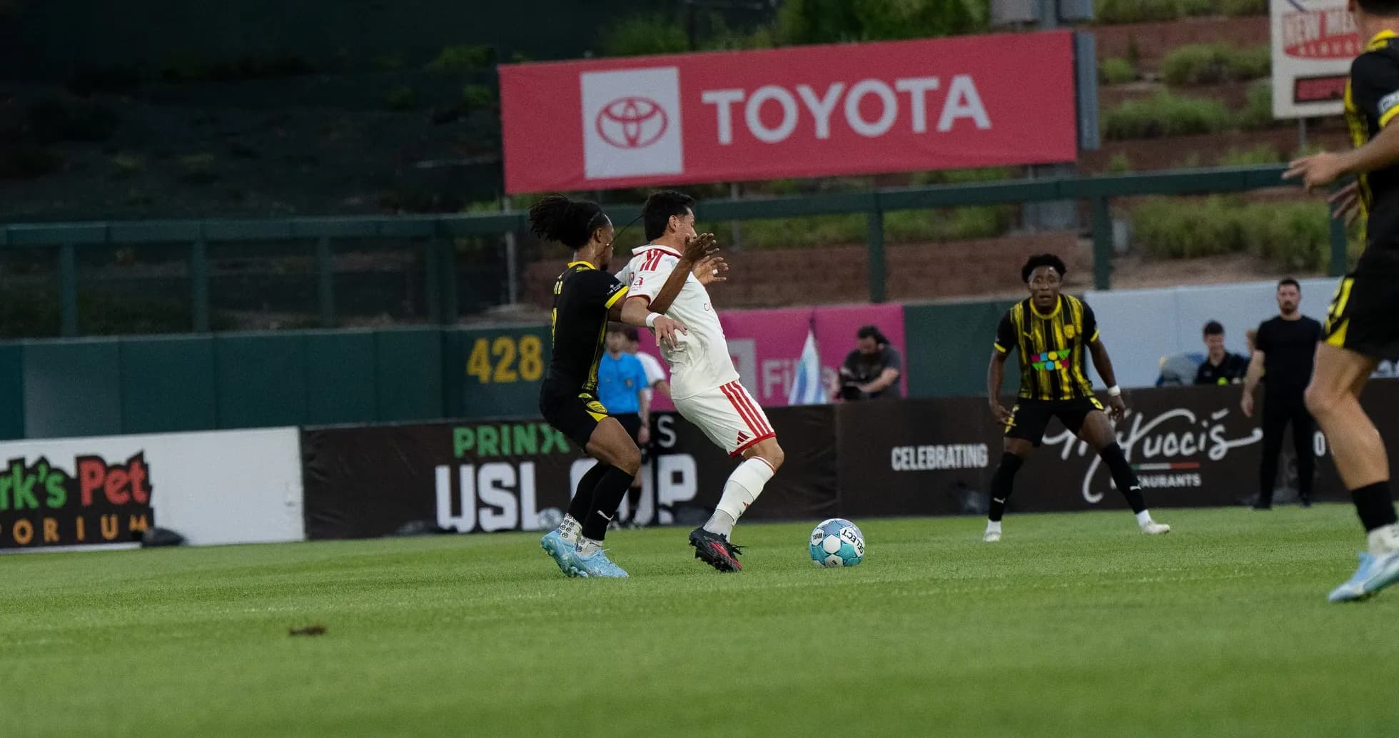 Players competing for the ball in USL match