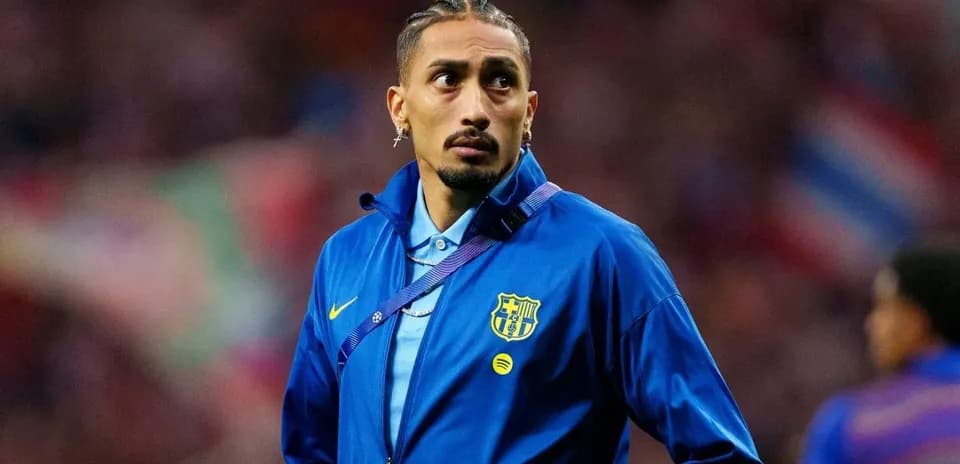 Player in Barcelona jacket on the sidelines