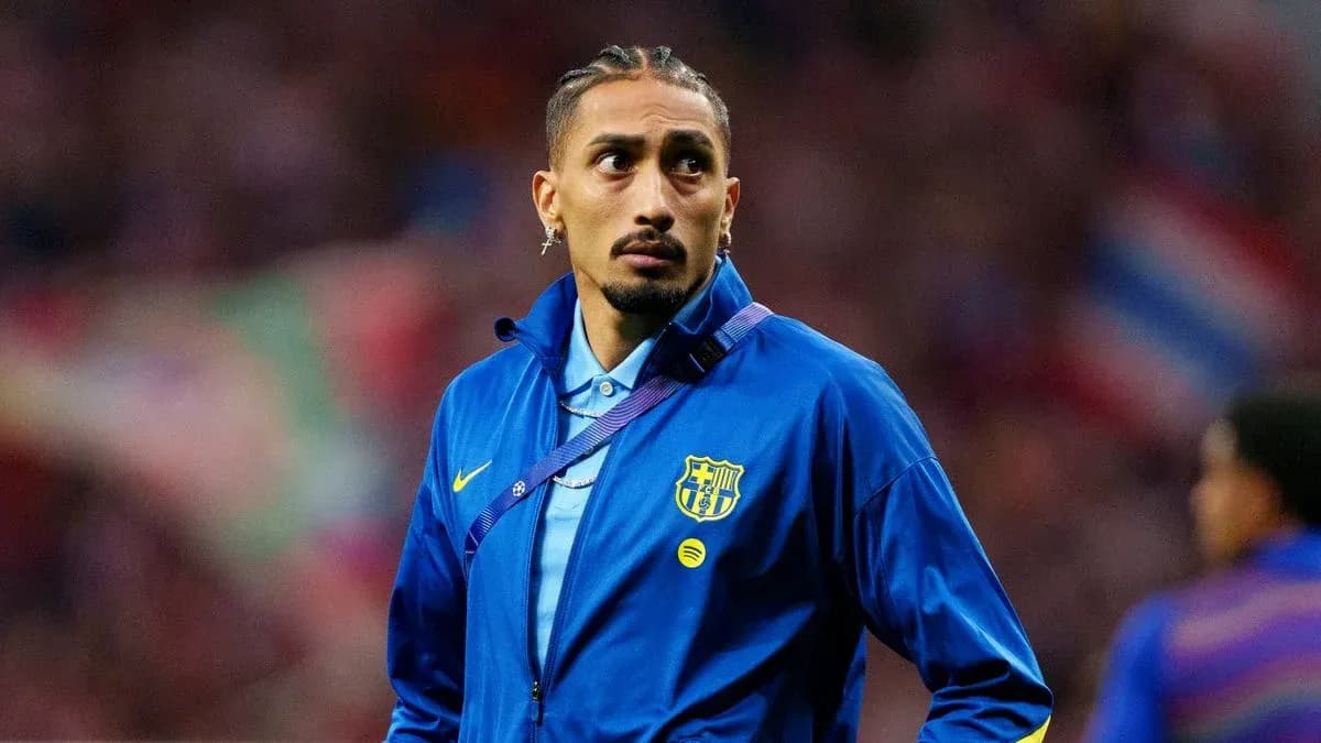Player in Barcelona jacket on the sidelines