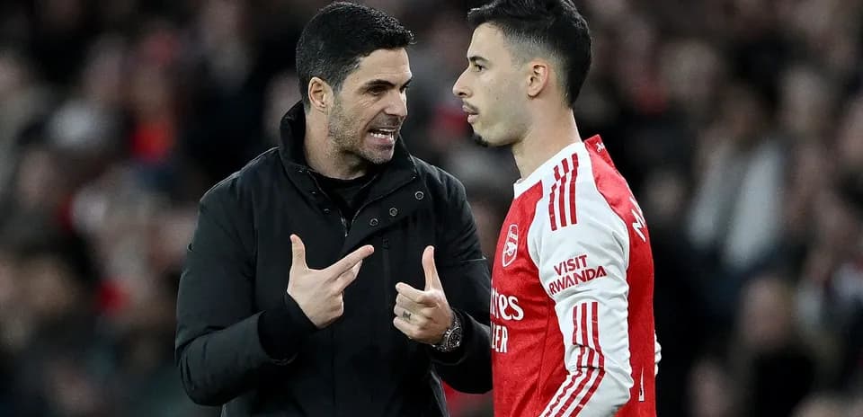 Manager discussing strategy with player on sideline