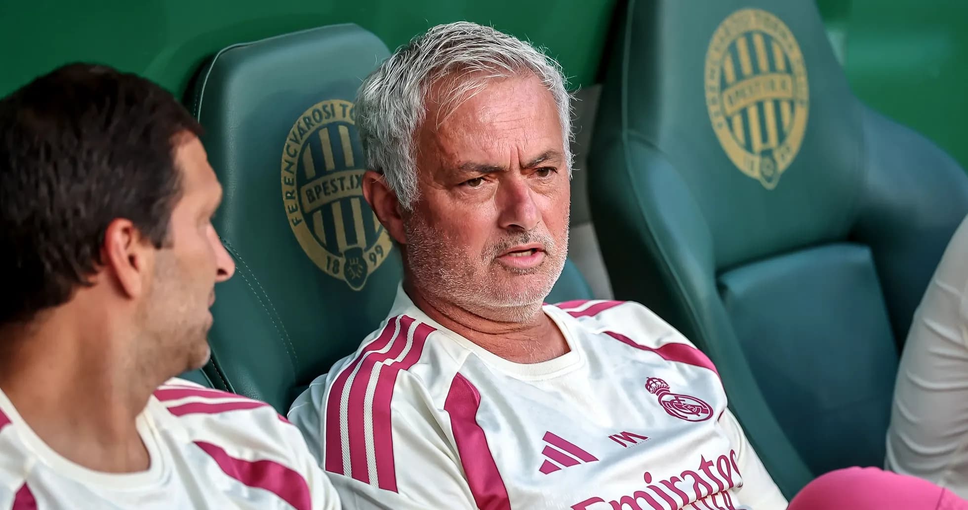 Manager discussing strategy on the bench during match