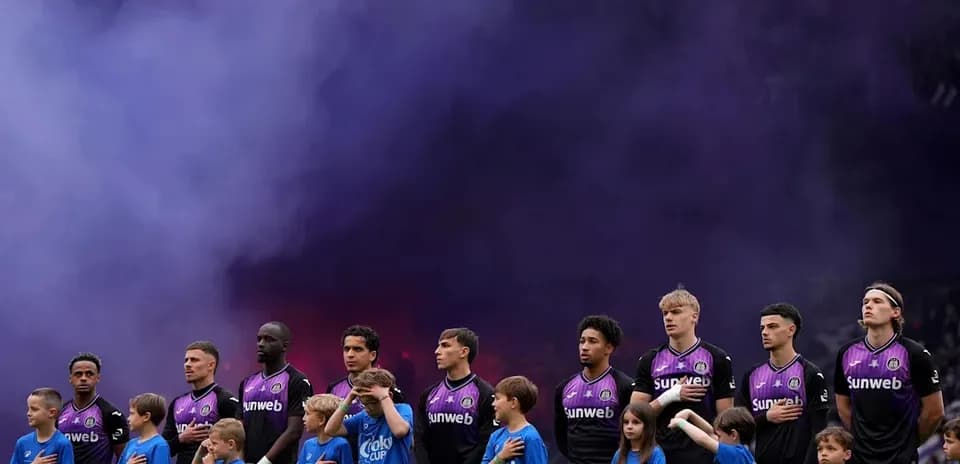 Team lineup with children during pre-match ceremony