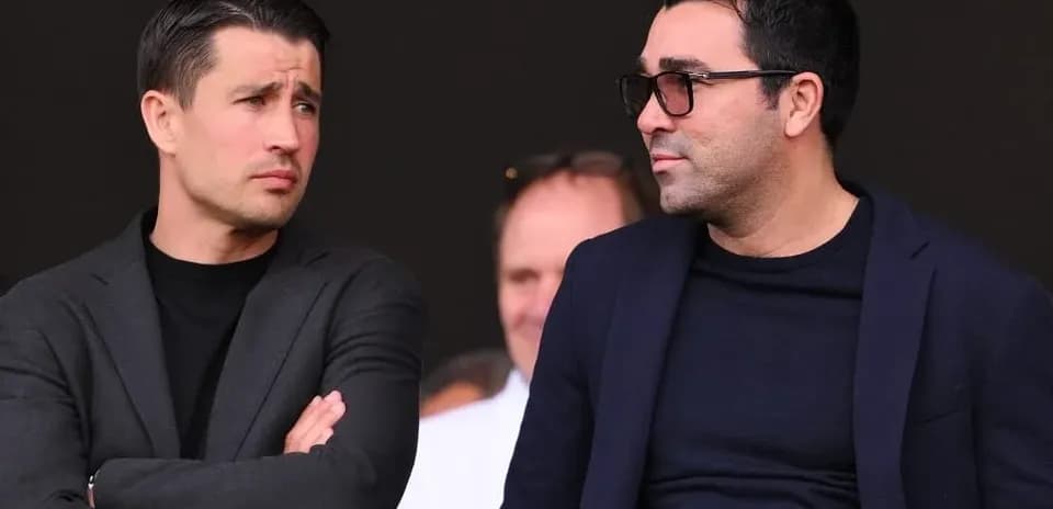 Two men talking in a sports venue