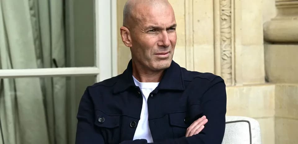 Man sitting with arms crossed, outdoors