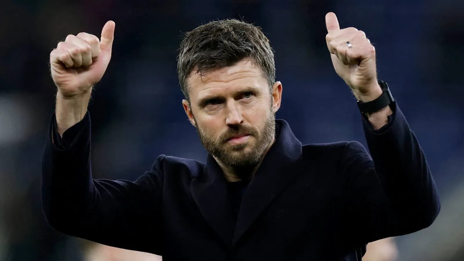 Coach giving thumbs up gesture after match