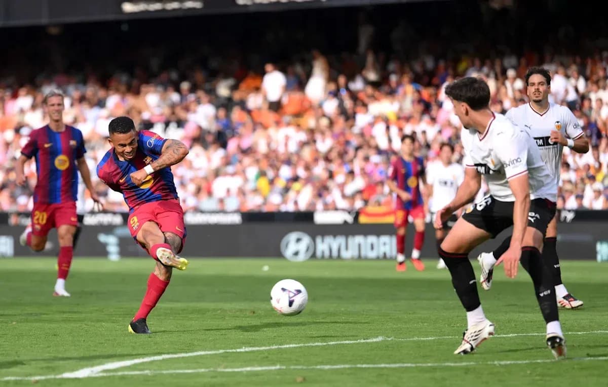 Barcelona player shooting during match against Valencia