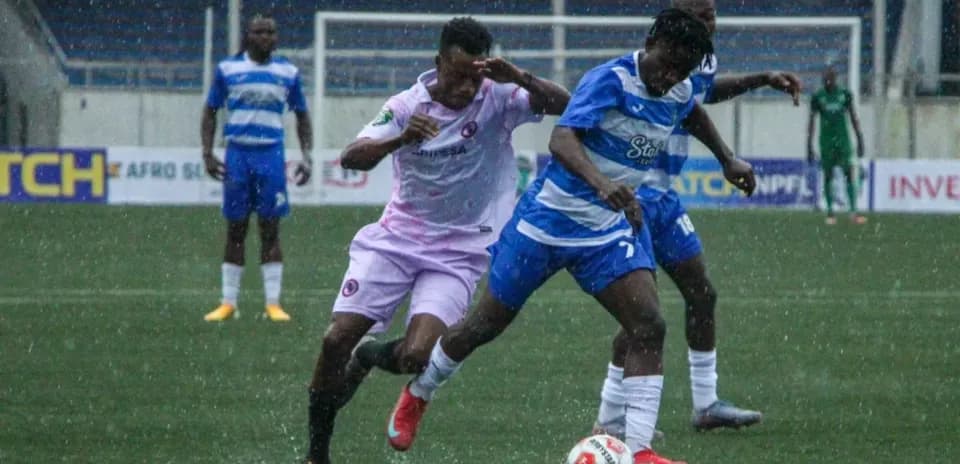 Players competing for the ball during Enyimba match