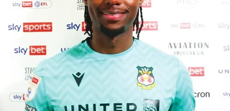 Goalkeeper in team jersey smiling for photo