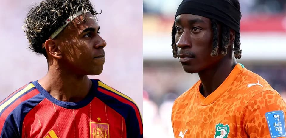 Two players in national team jerseys facing each other