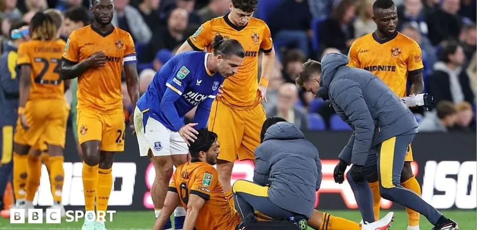Players and medical staff attending to injured player