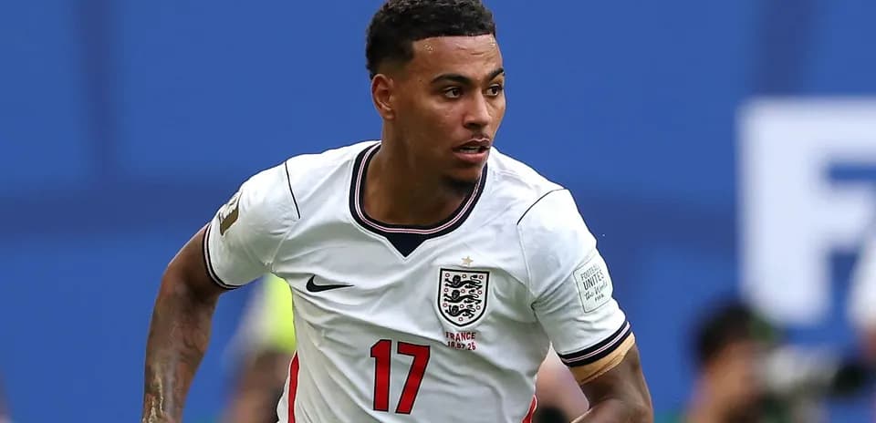 Player in England jersey running during match