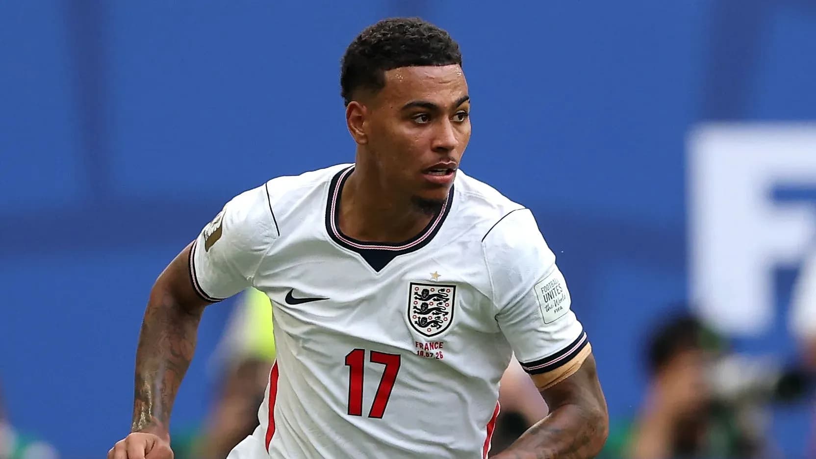 Player in England jersey running during match
