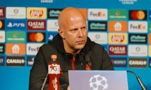 Manager at press conference with sponsor backdrop