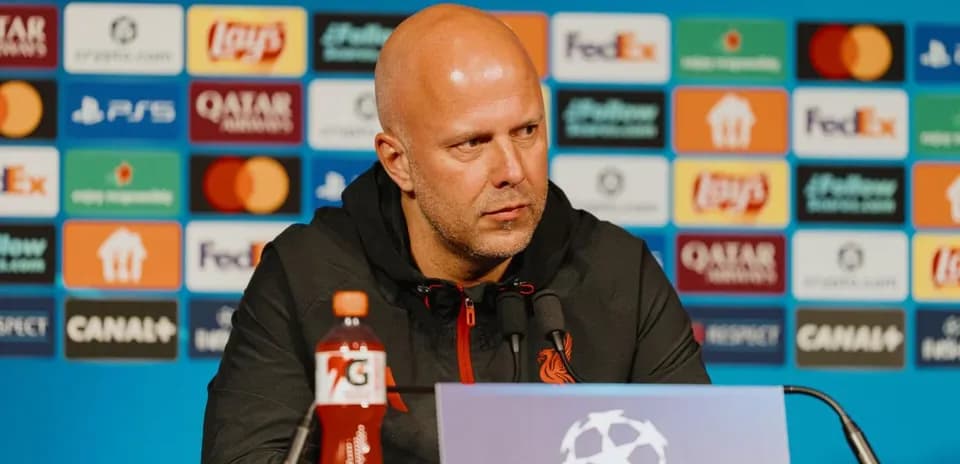 Manager at press conference with sponsor backdrop