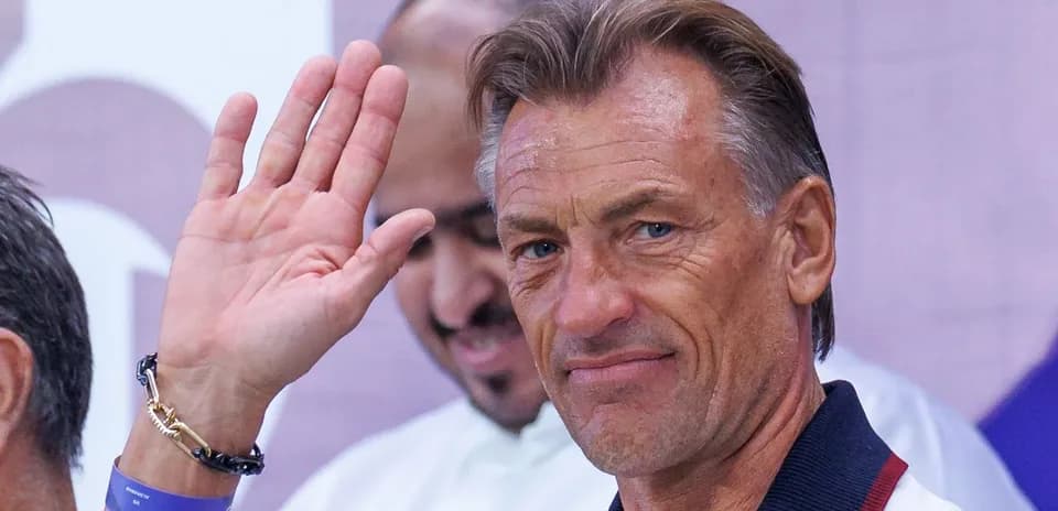 Coach waving during an event appearance