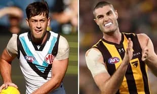 Two AFL players in action during a match