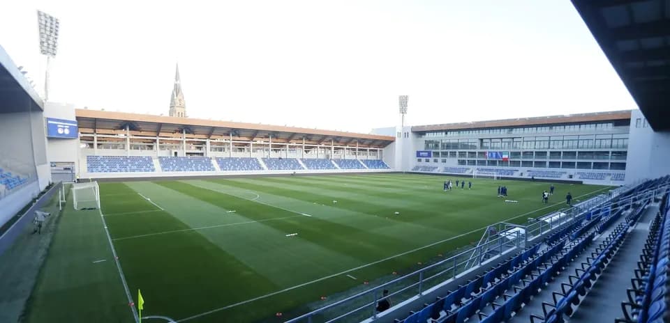 Football stadium with players training on the pitch