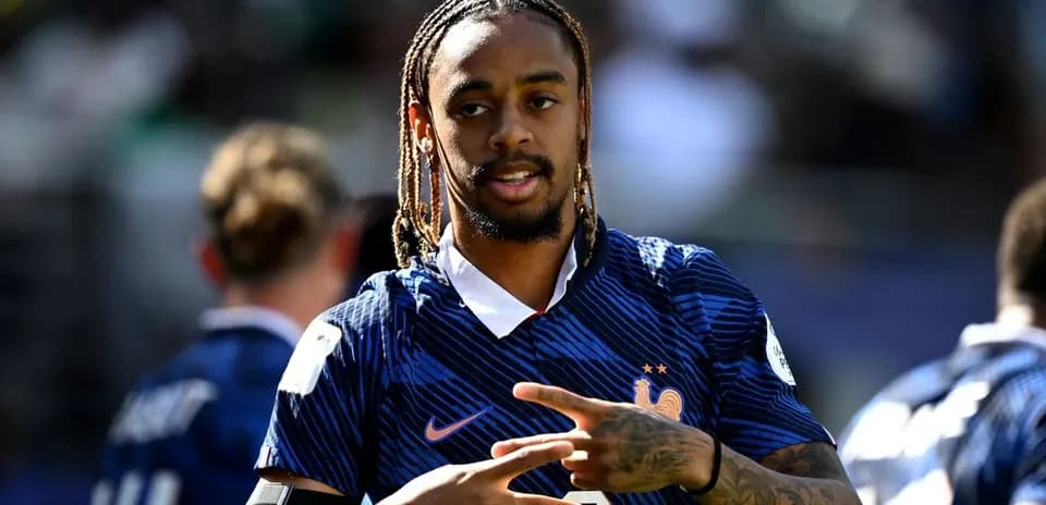Player in France kit gesturing during warm-up