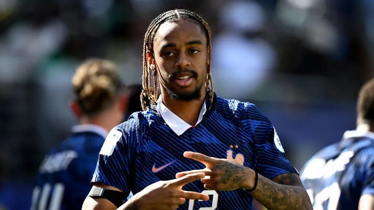 Player in France kit gesturing during warm-up