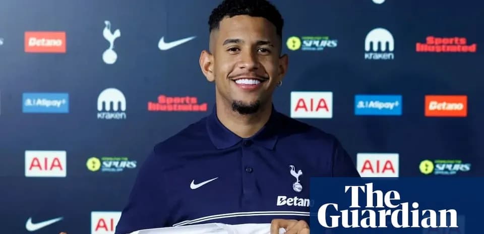 Player holding Tottenham Hotspur jersey at presentation