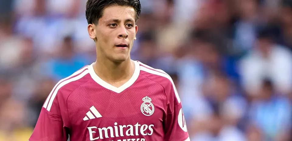 Player in pink Real Madrid jersey on the field
