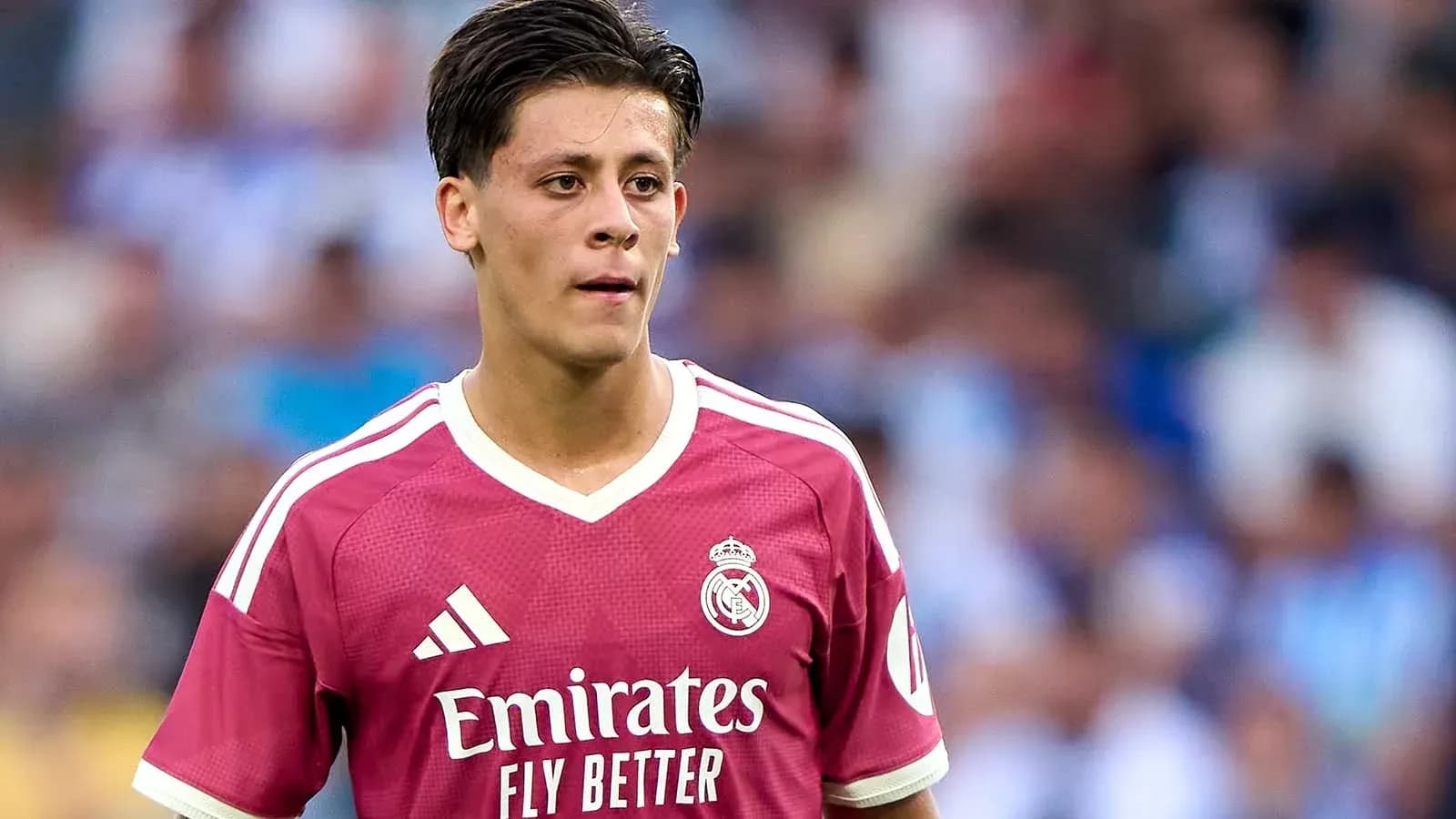 Player in pink Real Madrid jersey on the field