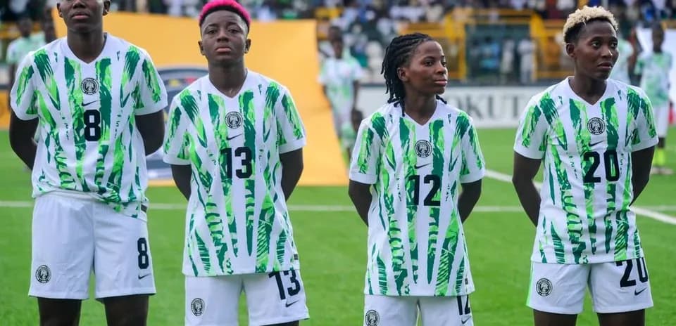 Four Nigerian players standing in team jerseys before match