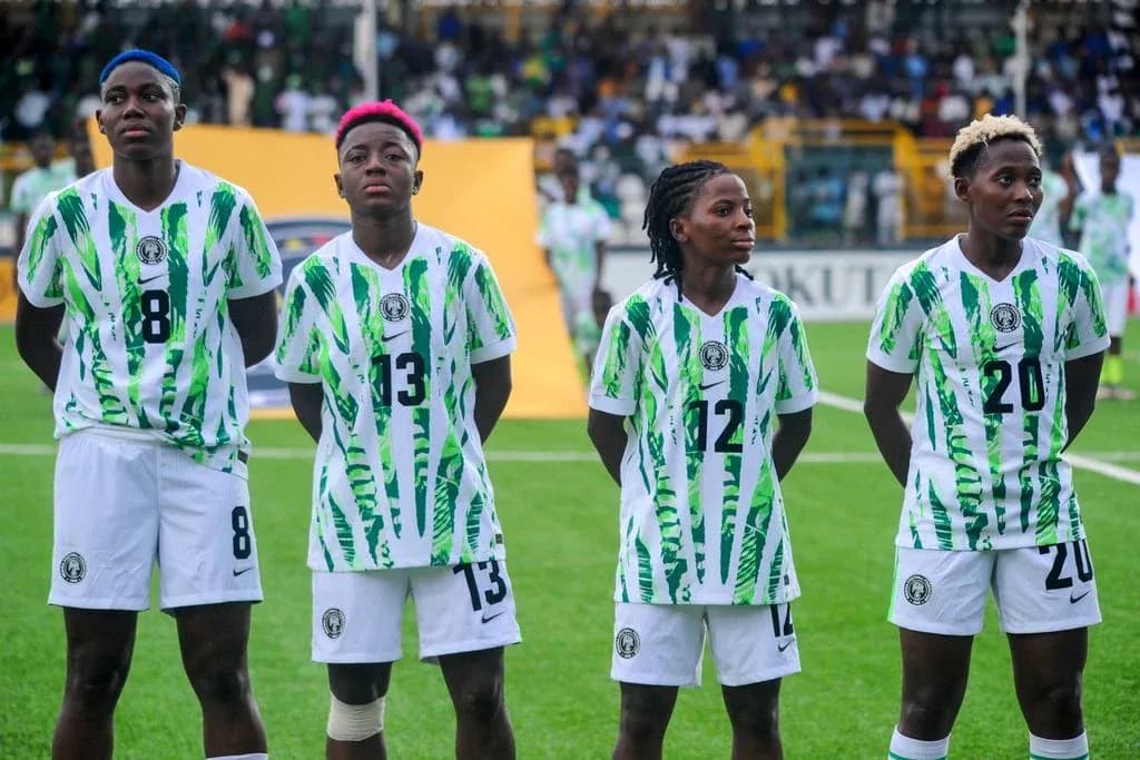 Four Nigerian players standing in team jerseys before match