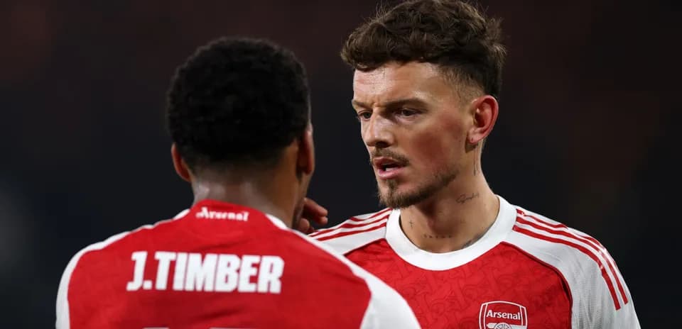 Two Arsenal players discussing on the pitch