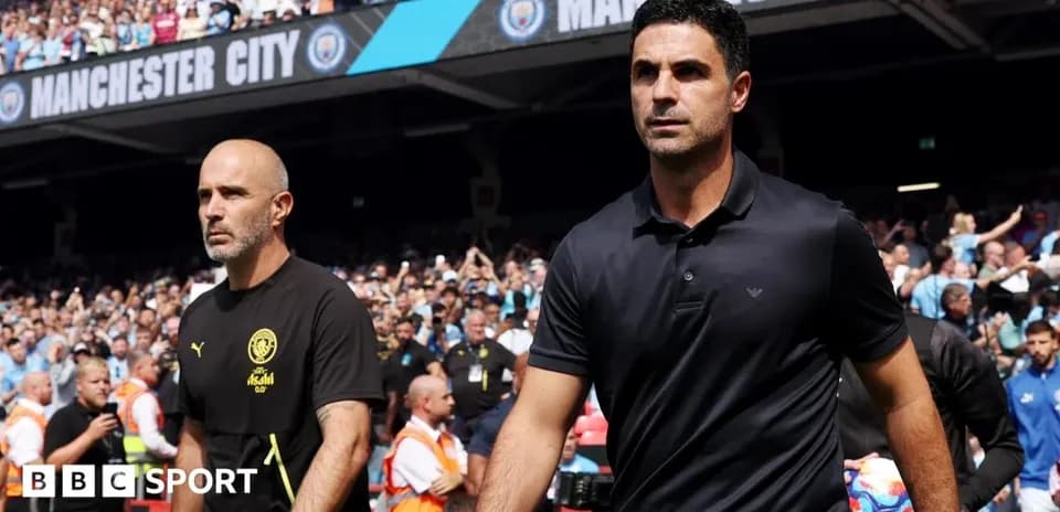Coaches walking onto the pitch before match