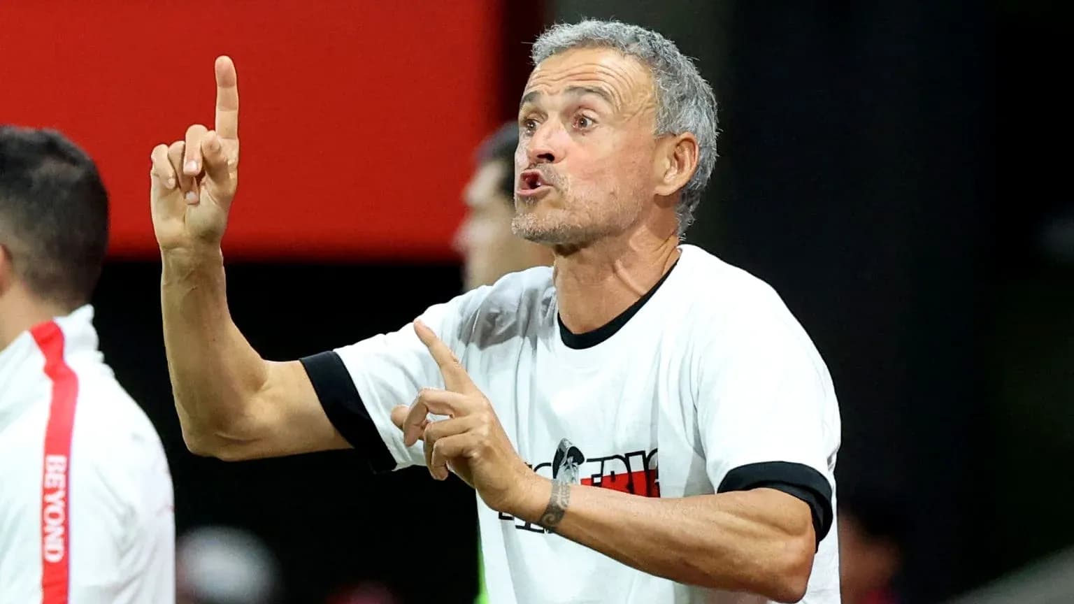 Coach gesturing during match from the sidelines
