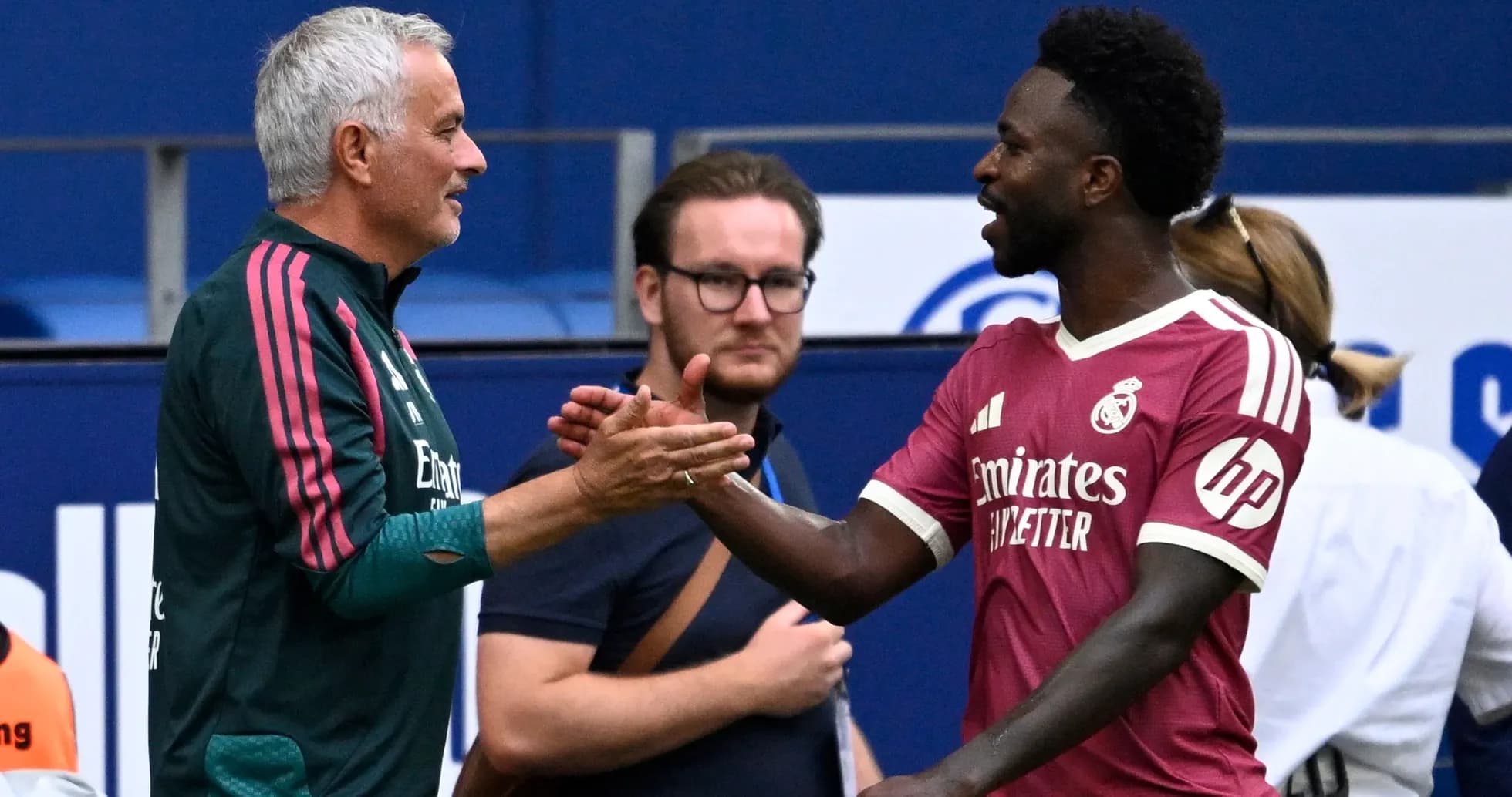 Manager and player shaking hands on the pitch