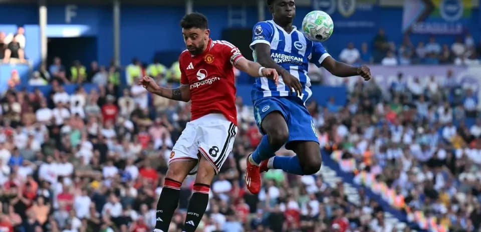 Player from Manchester United challenges Brighton player in mid-air