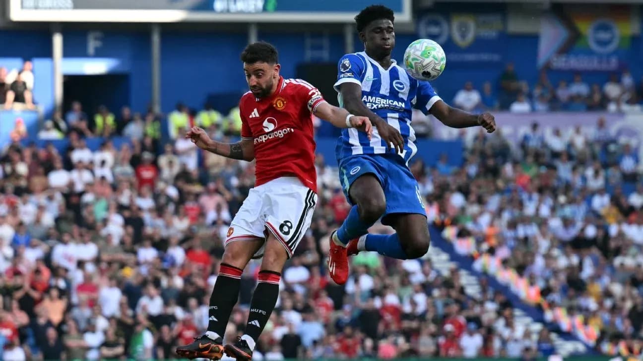 Player from Manchester United challenges Brighton player in mid-air
