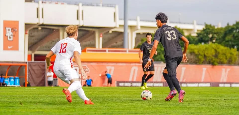 Player 12 chasing player 33 with soccer ball
