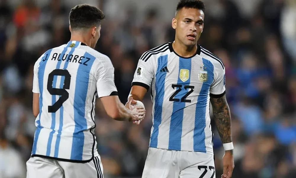 Two Argentina players shaking hands during match