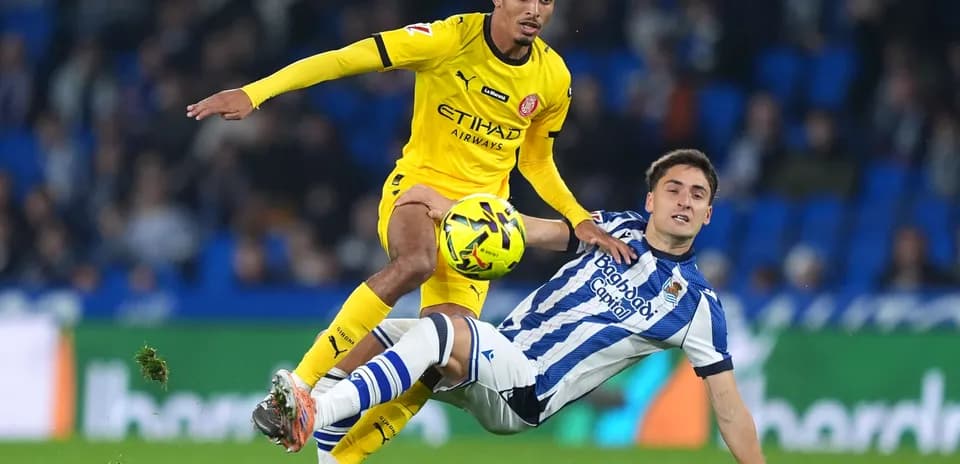 Player tackling opponent during Girona vs Real Sociedad
