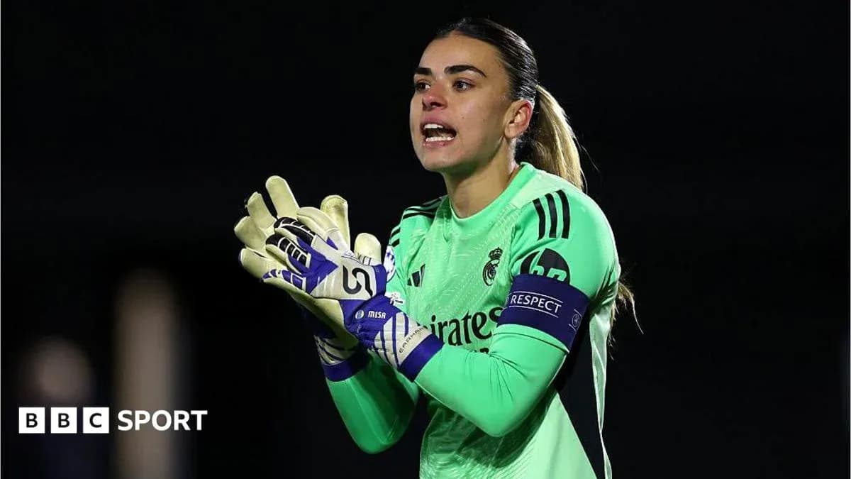 Goalkeeper in green kit directing teammates during match