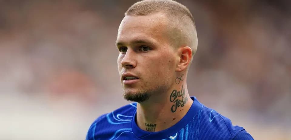 Player with tattoos wearing blue training shirt