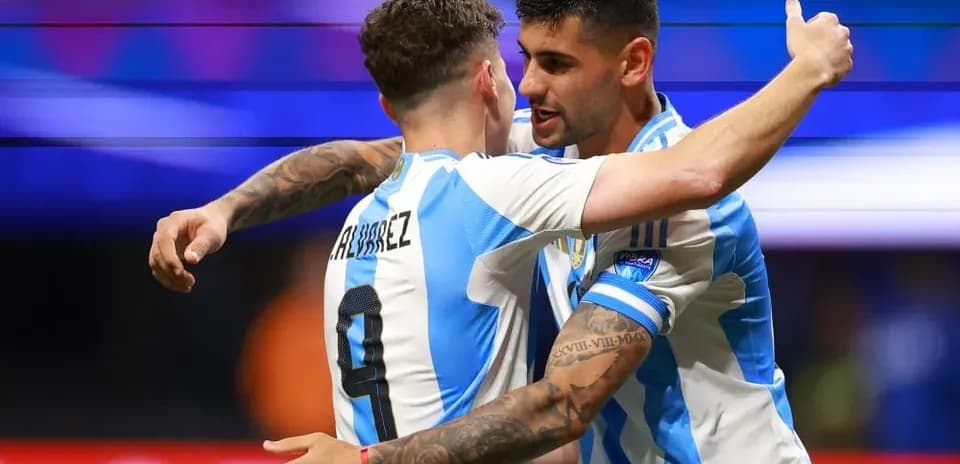 Two Argentine players celebrating a goal together